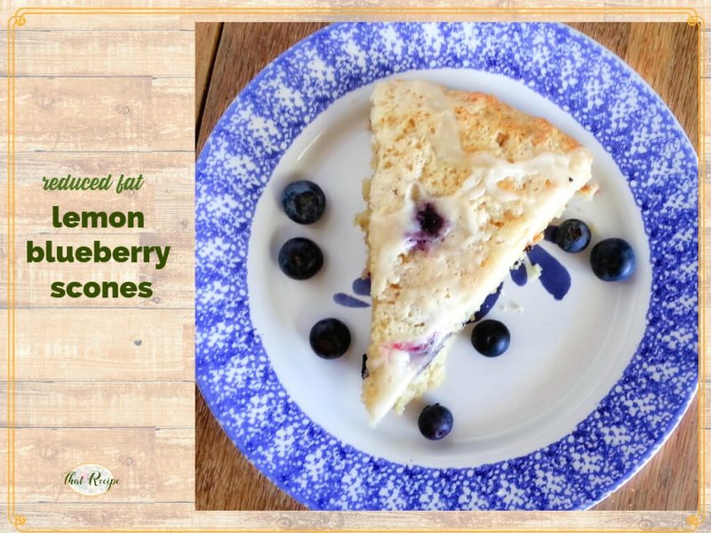 lemon blueberry scone on a plate with fresh blueberries
