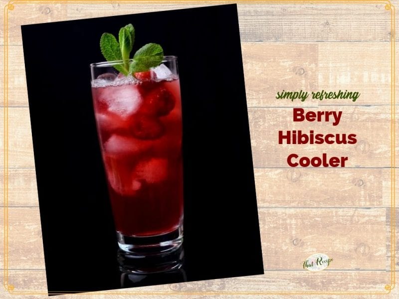 glass of hibiscus tea with raspberries and text overlay "Berry Hibiscus Cooler"