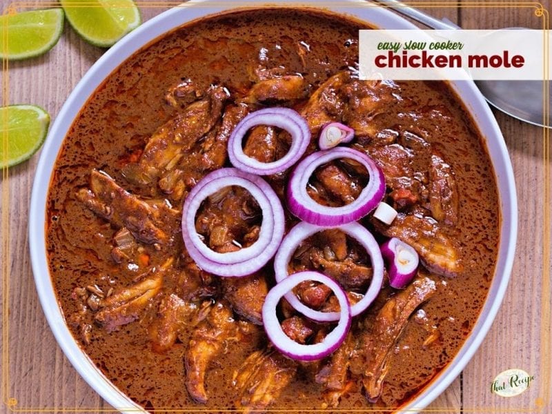bowl of chicken in chocolate broth with text overlay "easy slow cooker chicken mole"