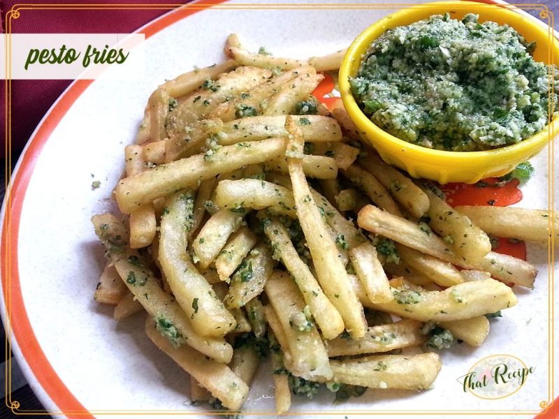 pesto fries on a plate with a side of homemade pesto