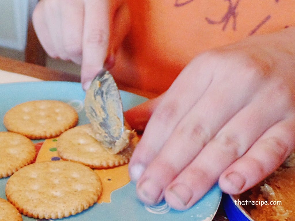 spread peanut butter on crackers
