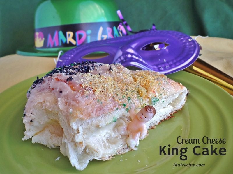King Cake on a table with text overlay "Cream Cheese filled King Cake"