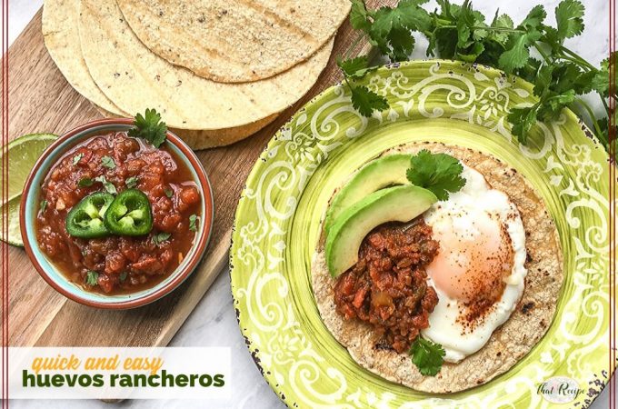 huevos rancheros on a plate with tortillas and a bowl of salsa