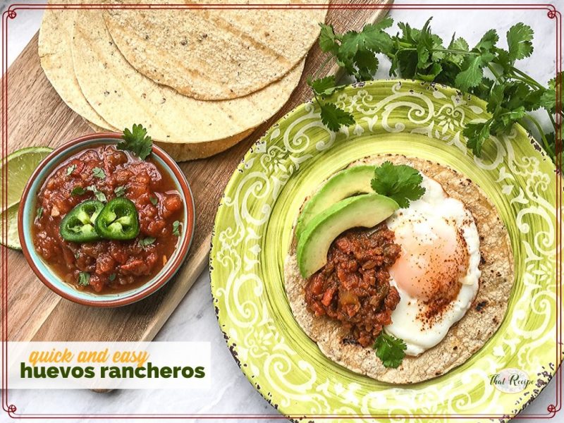 huevos rancheros on a plate with tortillas and a bowl of salsa