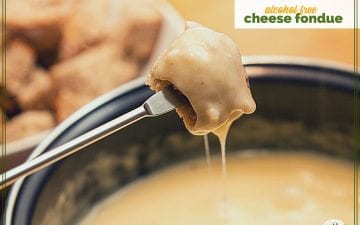 piece of bread dipped in cheese fondue with text overlay "alcohol free cheese fondue"