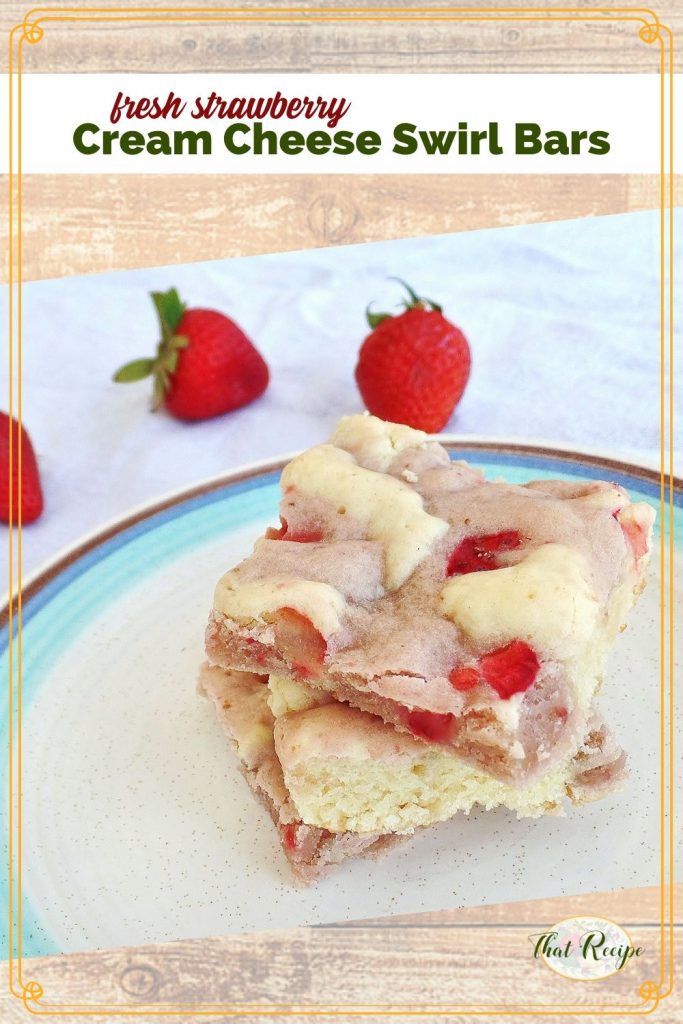 cookie bars on a plate with fresh strawberries in the background with text overlay "Fresh Strawberry Cream Cheese Swirl Bars"
