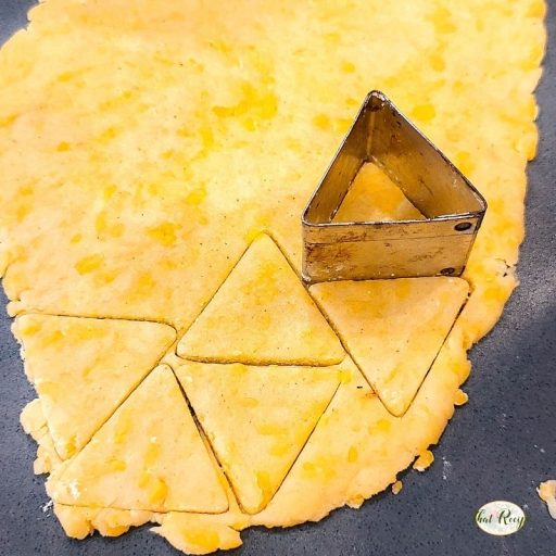 triangle cutter on cheese cracker dough
