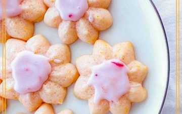 spritz cookies on a plate with text overlay "blood orange spritz cookies"