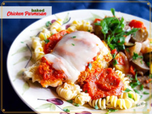baked chicken parmesan on a plate with pasta and vegetables