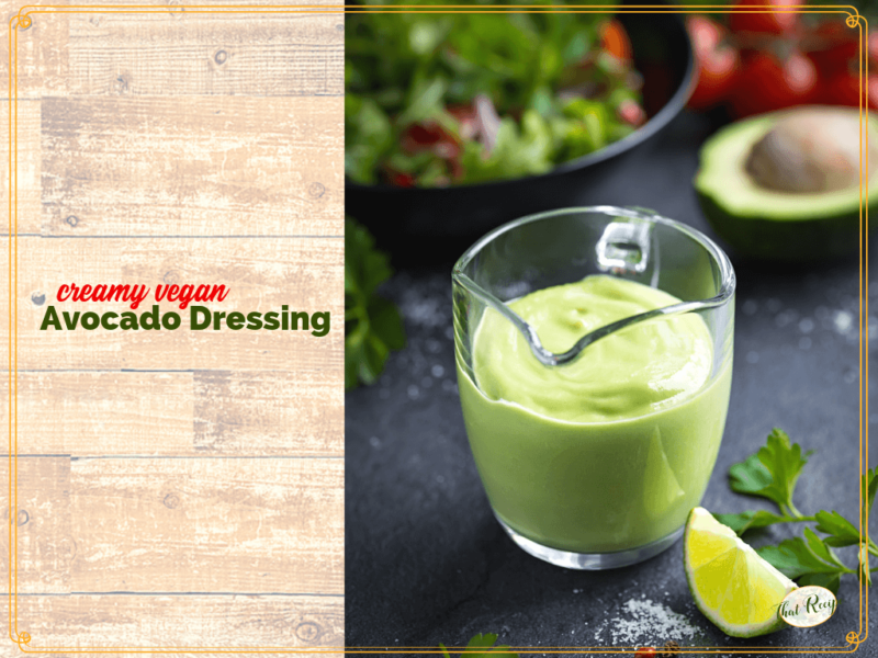 avocado salad dressing in a glass jug on a table with salad and text overlay "creamy vegan Avocado Salad Dressing"