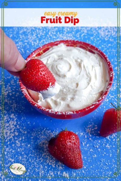 strawberry being dipped in bowl of creamy dip with text overlay "easy creamy fruit dip"