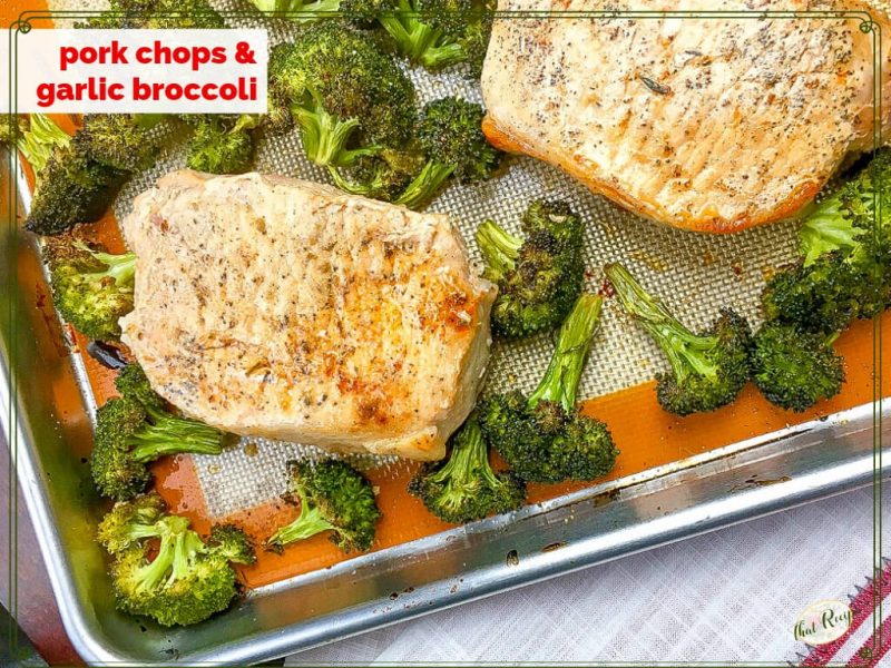 roasted pork chops and broccoli on a sheet pan.