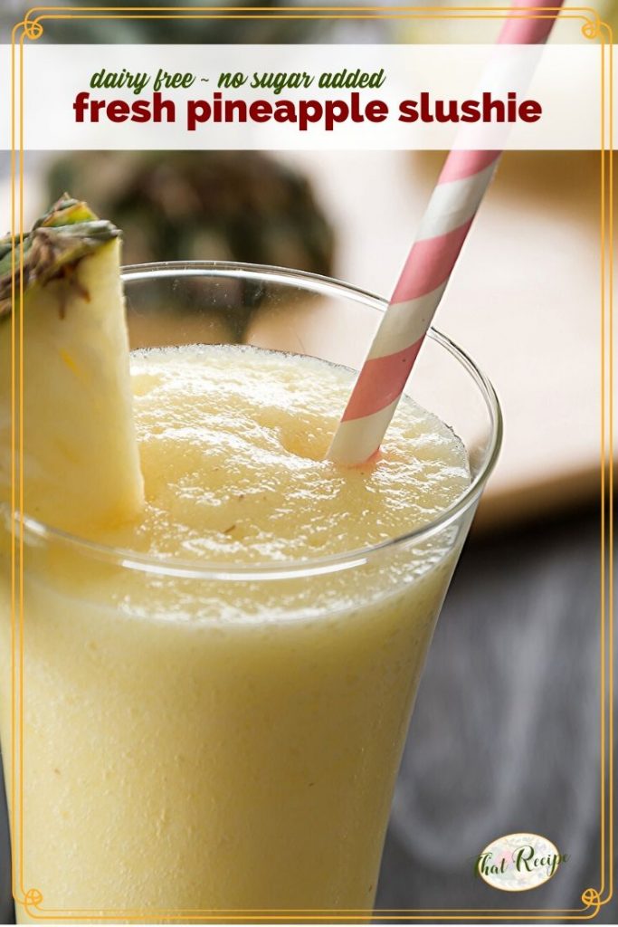 pineapple slushie on a table with fresh pineapple