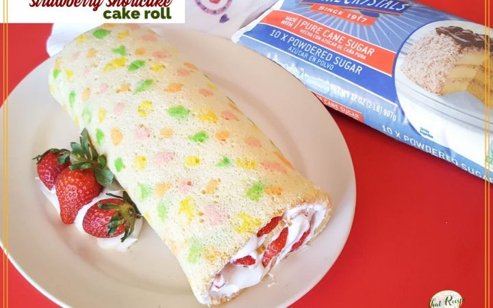 vanilla swiss cake roll with strawberries and whipped cream with text overlay "strawberry shortcake cake roll"