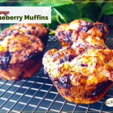 jumbo muffins on a cooling rack with text overlay "orange blueberry muffins"