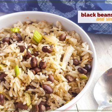 bowl of black beans and rice on white wood background with blue cloth