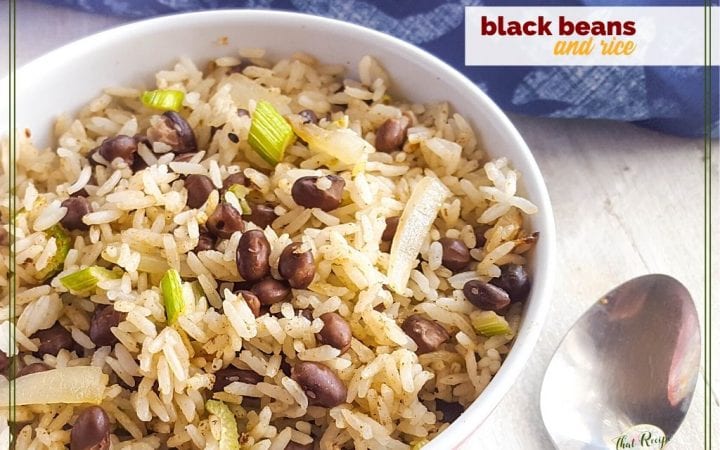 bowl of black beans and rice on white wood background with blue cloth