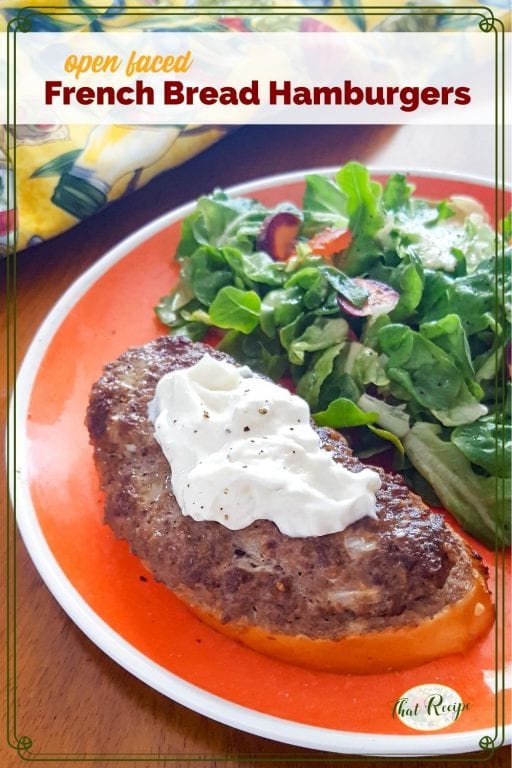 open faced burger on a plate with a green salad and text overlay "Open Faced French Bread Hamburger"