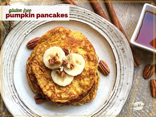 top down view of pancakes on a plate topped with pecans and banana slices and text overlay "gluten free pumpkin pancakes"