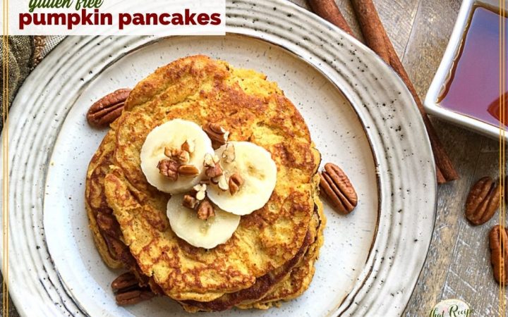 top down view of pancakes on a plate topped with pecans and banana slices and text overlay "gluten free pumpkin pancakes"