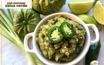 bowl of salsa verde with limes, tomatillos, peppers and onions surrounding it and text overlay "fresh homemade salsa verde"
