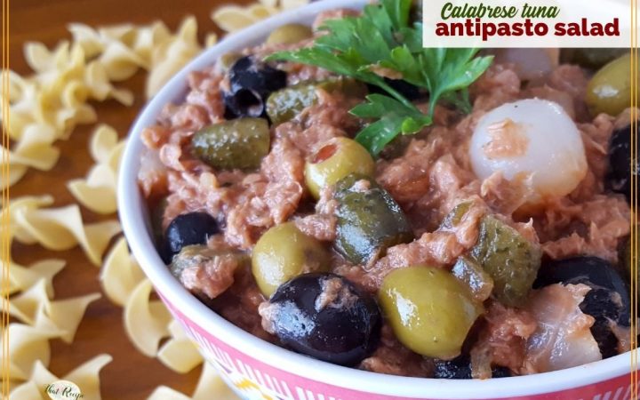 bowl of antipasto salad on a table surrounded by pasta with text overlay "Calabrese tuna Antipasto Salad"