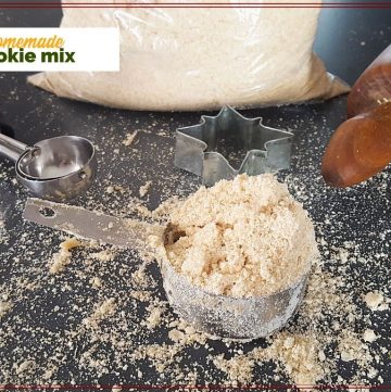 cup of cookie mix on a counter with cookie scoop and rolling pin and text overlay "homemade cookie mix"