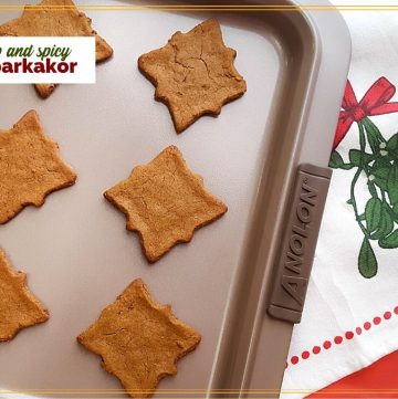 cut out cookies on a baking tray with text overlay "sweet and spicy Pepparkakor"