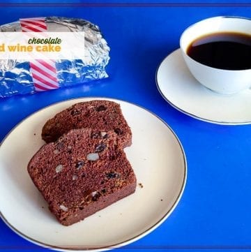 slices of chocolate loaf cake on a plate with foil wrapped loaf and coffee and text overlay "chocolate red wine cake"