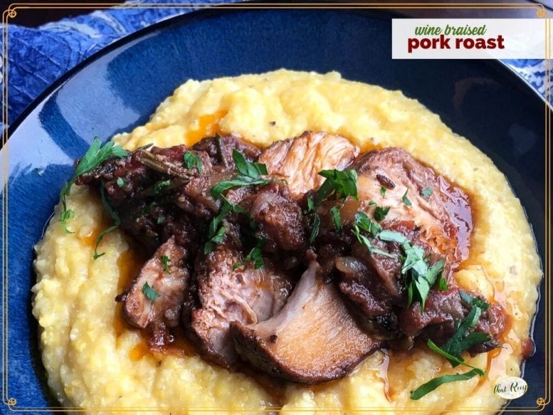 top down view of pork slices on polenta with text overlay "wine braised pork roast"