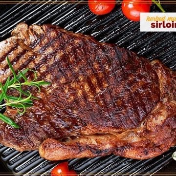 sirloin steak and tomatoes on a cast iron griddle with text overlay "herbed mustard sirloin"