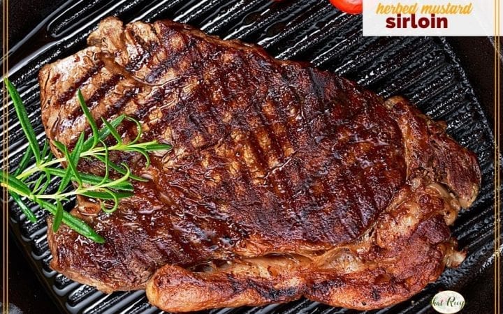 sirloin steak and tomatoes on a cast iron griddle with text overlay "herbed mustard sirloin"