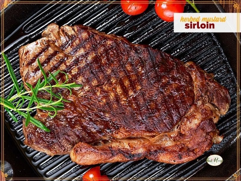 sirloin steak and tomatoes on a cast iron griddle with text overlay "herbed mustard sirloin"