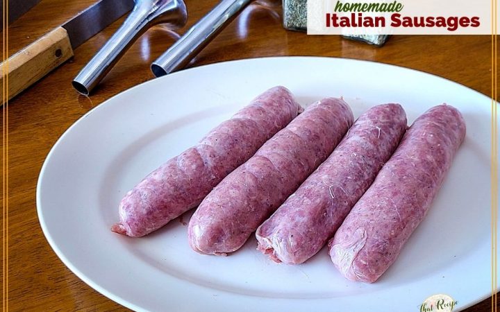 Homemade sausages on a plate with sausage making tools and herbs and text overlay "Homemade Italian Sausages"