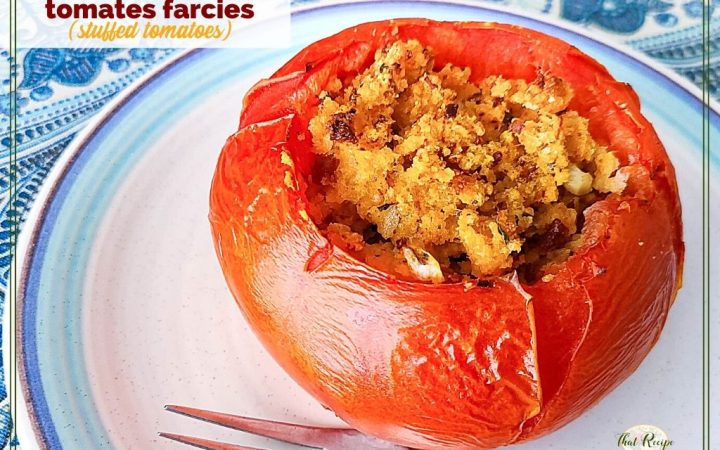 stuffed tomato on a plate with text overlay "tomates farcies"