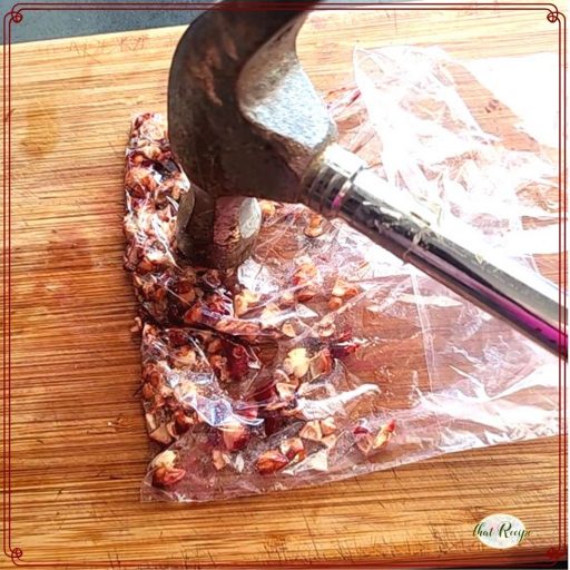 hammer pounding cherry stones in a plastic baggy