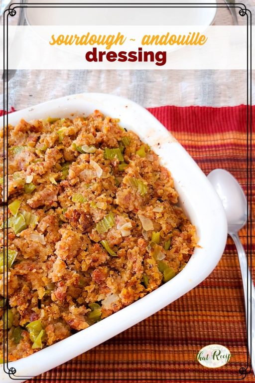 stuffing in a casserole dish with text overlay "sourdough andouille dressing"