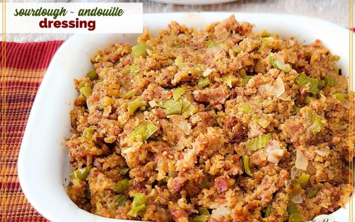 stuffing in a casserole dish with text overlay "sourdough andouille dressing"