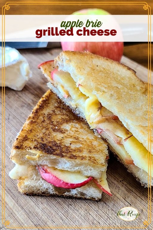 grilled cheese sandwich on cutting board with brie and apple and text overlay "apple brie grilled cheese sandwich"