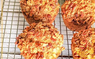 carrot muffins topped with granola on a cooling rack