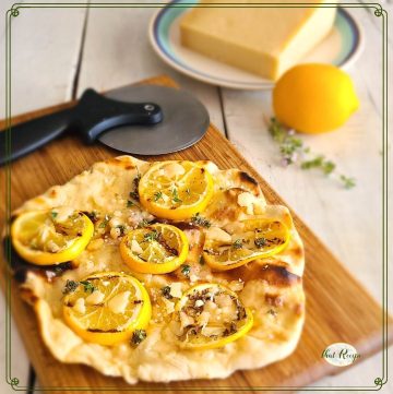 flatbread with grilled lemon slices and text overlay "grilled lemon herb flatbread"
