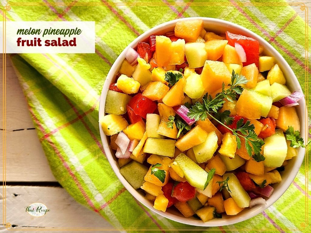 Fruit salad in a bowl with text overlay "Melon Pineapple Fruit Salad"