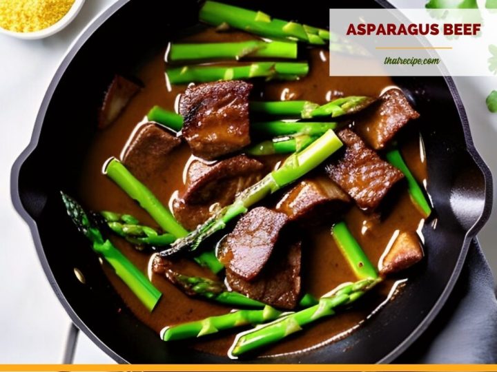 beef tips and asparagus in dark sauce in a skillet