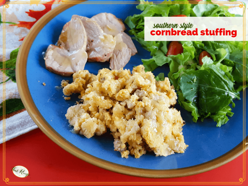 cornbread stuffing on a plate with sliced turkey and salad