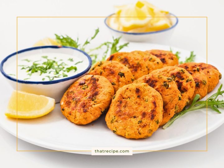 salmon cakes on a plate with creamy feta sauce