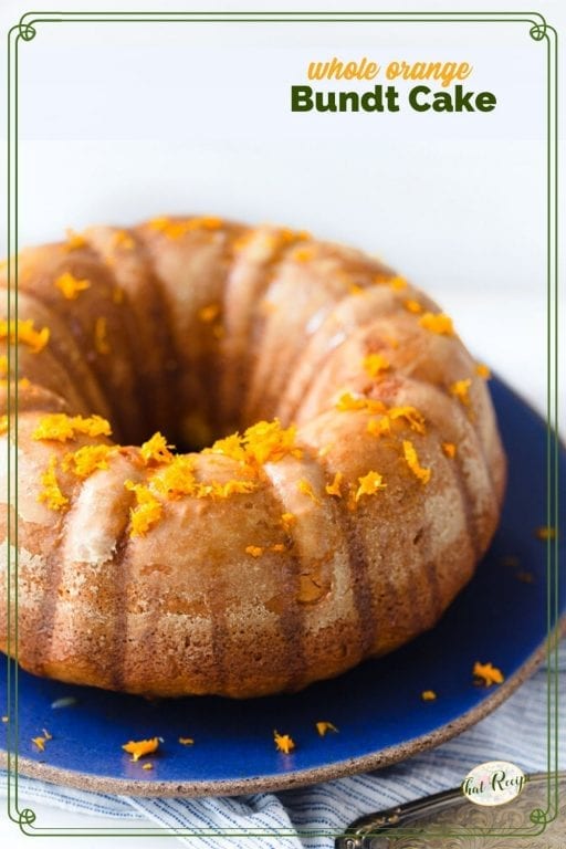 bundt cake on a plate topped with orange zest and text overlay "whole orange Bundt cake"