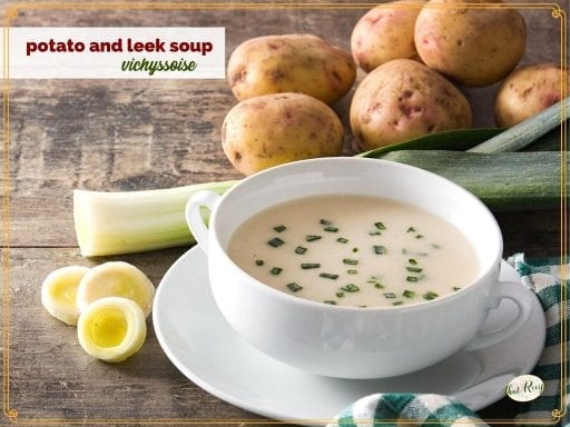potato soup in a bowl surrounded by potatoes and leeks and text overlay "vichyssoise potato and leek soup"