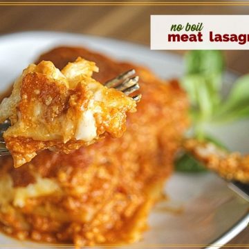 fork holidng a piece of lasagna with text overlay "no boil meat lasagna"