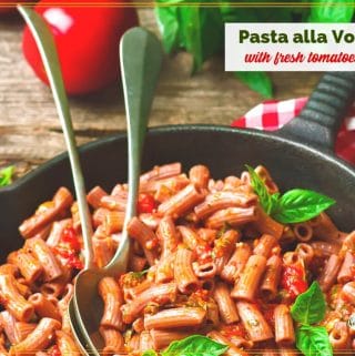 pasta in a skillet with text overlay "Pasta alla Vodka with fresh tomatoes"