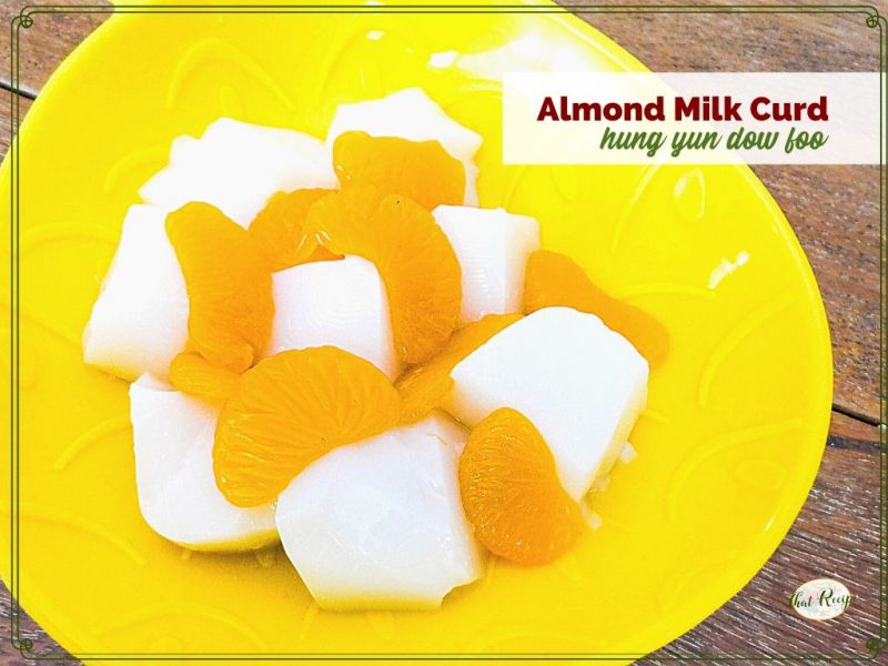 bowl of white gelatin cubes and mandarin oranges with text overlay "almond milk curd: hung yun dow foo"